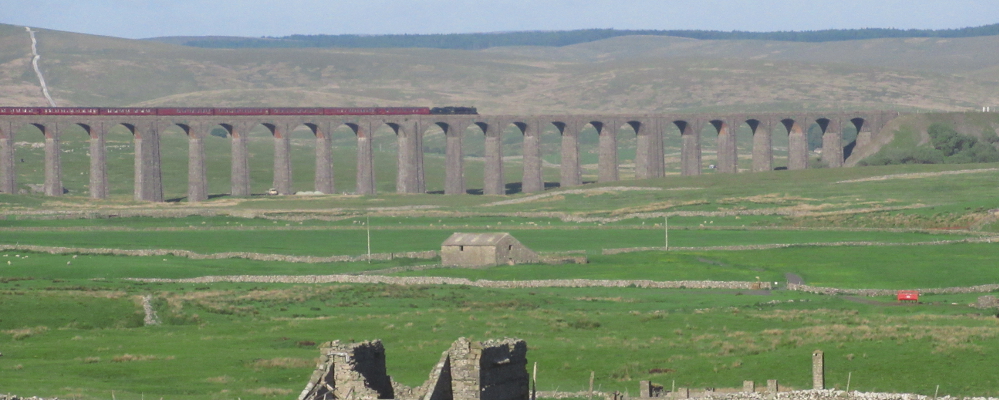 steam train crossing Ribblehead Viaduct